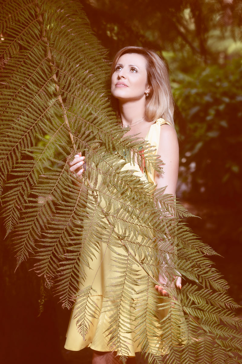 Beautiful pregnant woman and fern